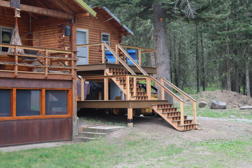 Deck - large rustic backyard second story cable railing deck idea with a bbq area and no cover