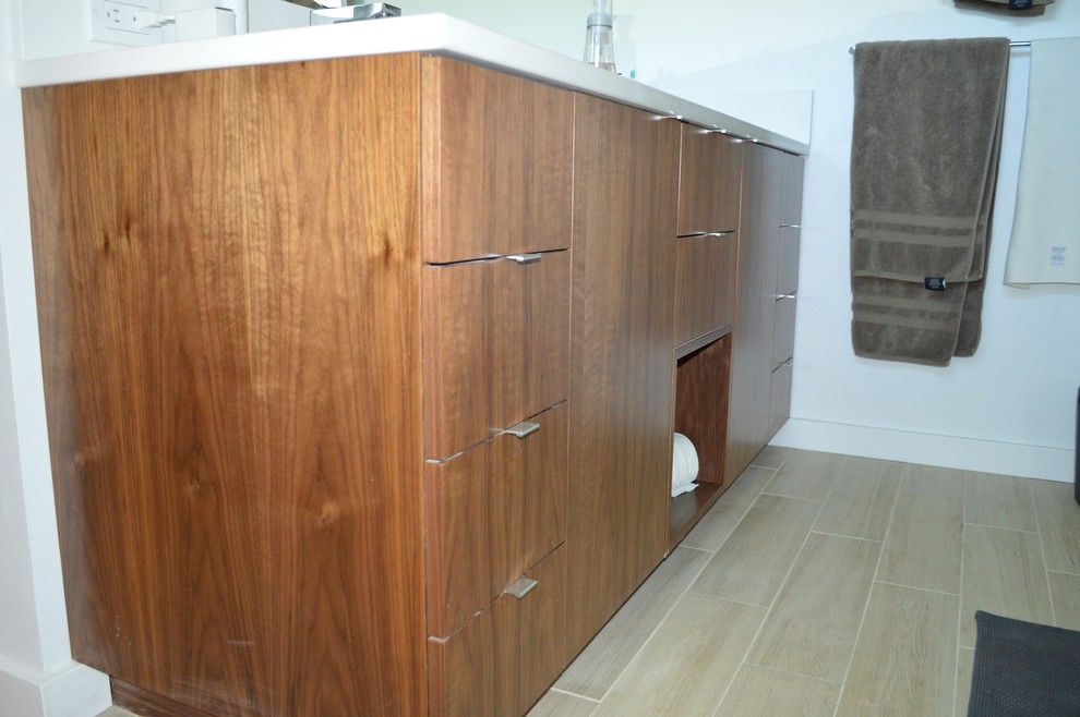 Small midcentury bathroom in Portland with flat-panel cabinets and medium wood cabinets.