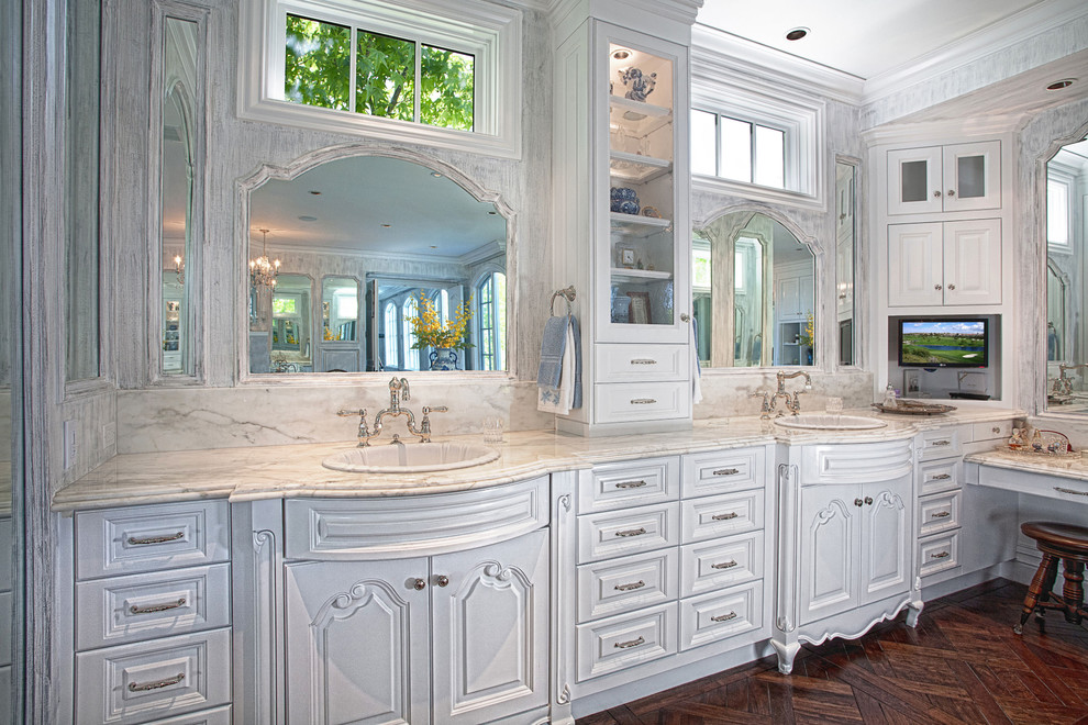 Traditional bathroom in Orange County with a drop-in sink, raised-panel cabinets and white cabinets.
