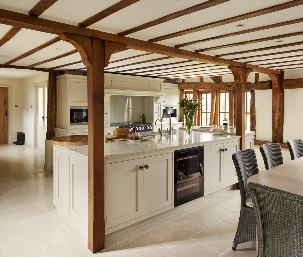 Design ideas for a country galley kitchen in London with shaker cabinets, white cabinets, with island and beige floor.