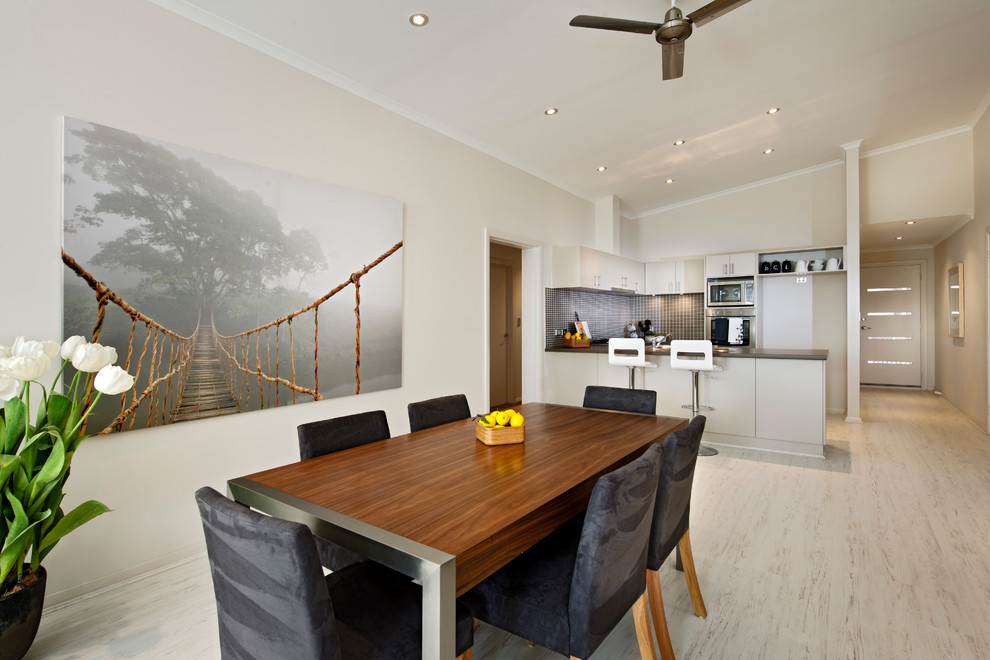 Transitional kitchen/dining combo in Perth with white walls and light hardwood floors.
