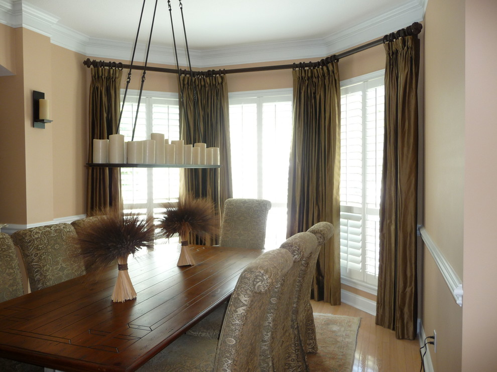 Design ideas for a mid-sized transitional separate dining room in Jacksonville with beige walls, light hardwood floors and no fireplace.