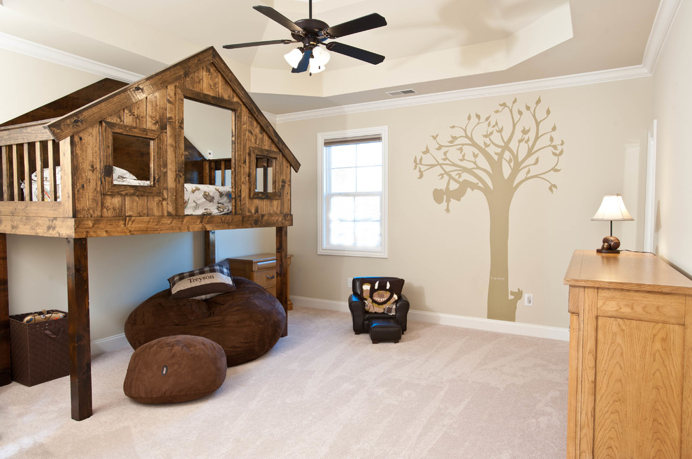 This is an example of a traditional kids' room for kids 4-10 years old and boys in Nashville with beige walls, carpet and beige floor.