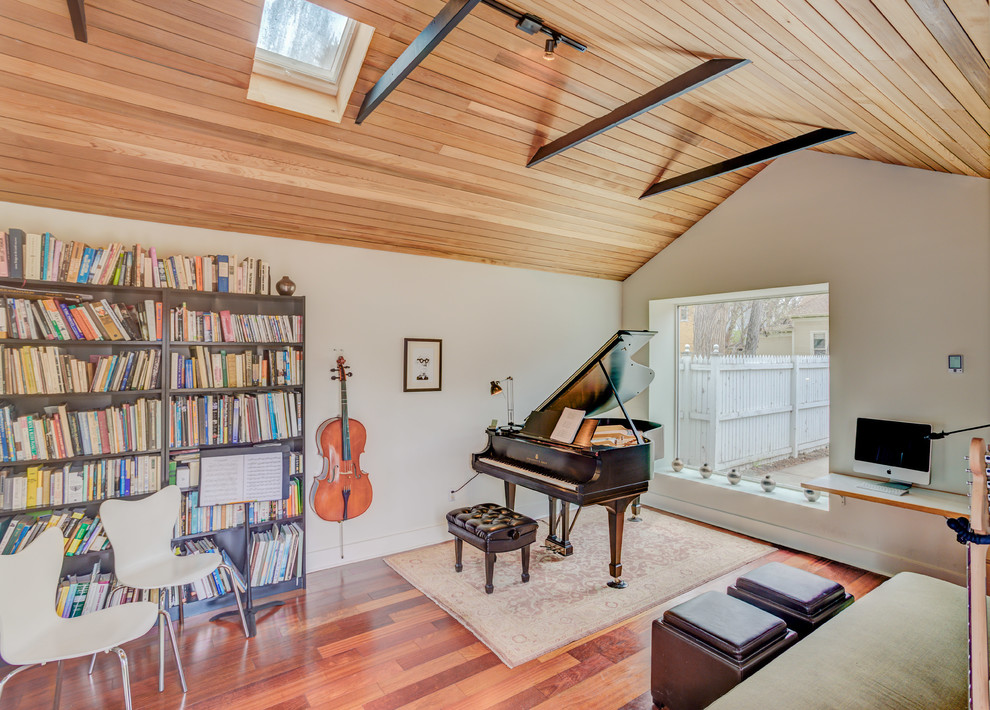 Inspiration for a mid-sized contemporary enclosed family room in Denver with a music area, white walls, medium hardwood floors, no fireplace and no tv.