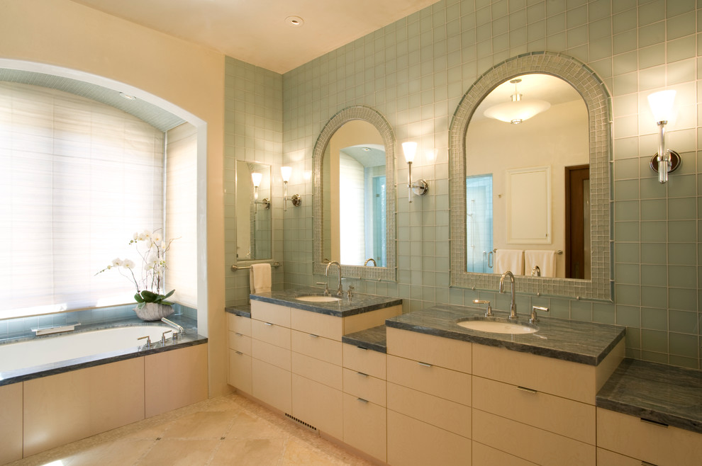 Inspiration for a large transitional master bathroom in San Francisco with flat-panel cabinets, light wood cabinets, an undermount tub, a corner shower, a bidet, blue tile, glass tile, beige walls, limestone floors, an undermount sink and marble benchtops.
