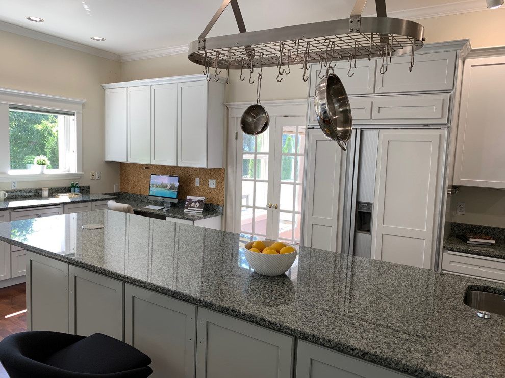 Inspiration for a large transitional single-wall dark wood floor and brown floor enclosed kitchen remodel in Seattle with an undermount sink, shaker cabinets, white cabinets, granite countertops, gray backsplash, metal backsplash, stainless steel appliances, an island and gray countertops