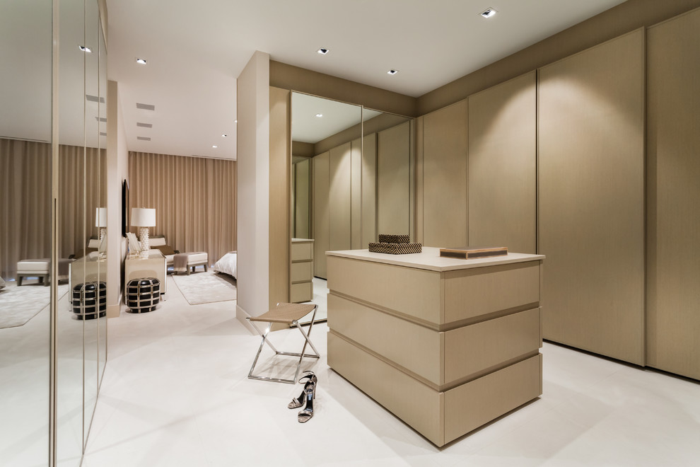 Photo of a contemporary storage and wardrobe in Miami with flat-panel cabinets and light wood cabinets.