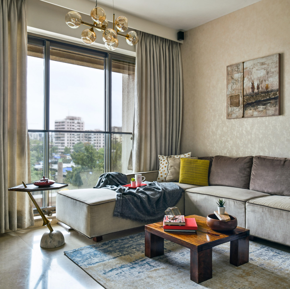 This is an example of a contemporary living room in Mumbai with beige walls, concrete flooring and grey floors.