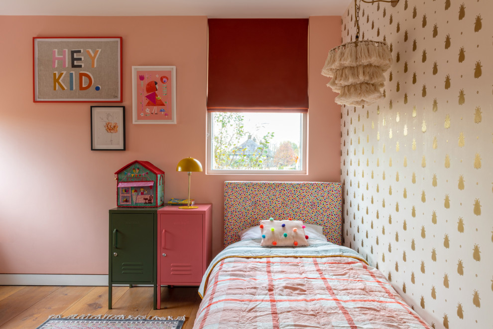 Medium sized contemporary guest bedroom in London with pink walls, light hardwood flooring and wallpapered walls.