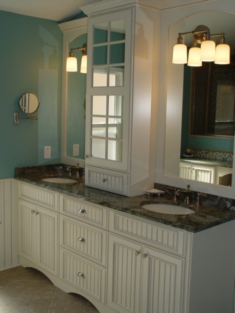 Photo of a large beach style master bathroom in Miami with white cabinets, an alcove tub, an alcove shower, a one-piece toilet, beige tile, blue tile, gray tile, green tile, multi-coloured tile, white tile, mosaic tile, blue walls, porcelain floors, an undermount sink, marble benchtops and recessed-panel cabinets.