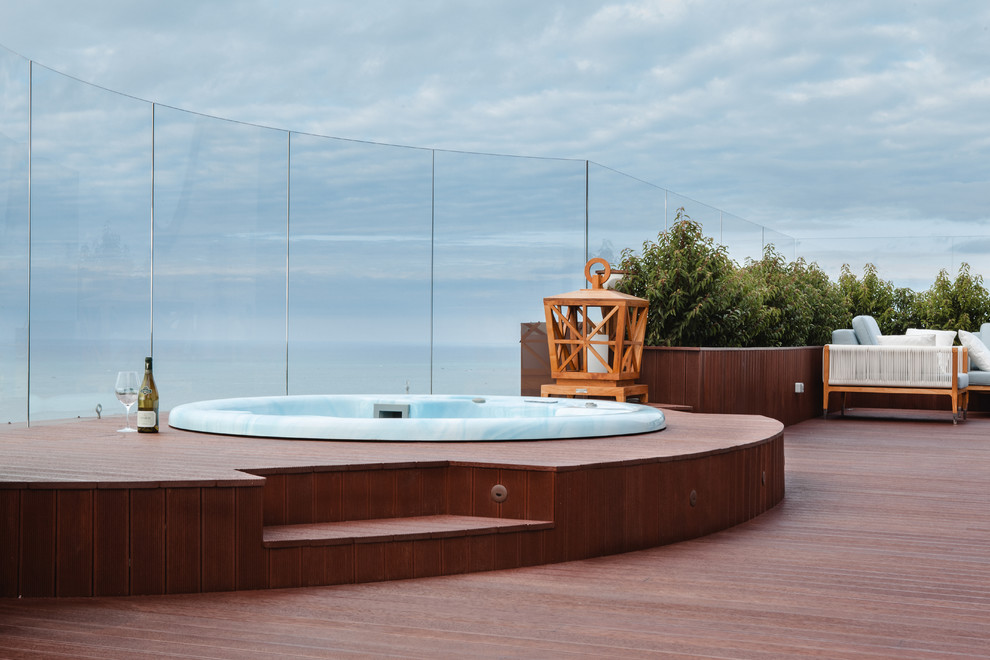 This is an example of a contemporary pool in Other with a hot tub.