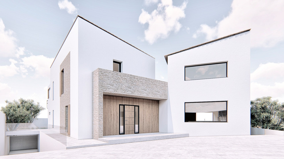 Esempio della facciata di una casa grande bianca mediterranea a due piani con copertura in tegole
