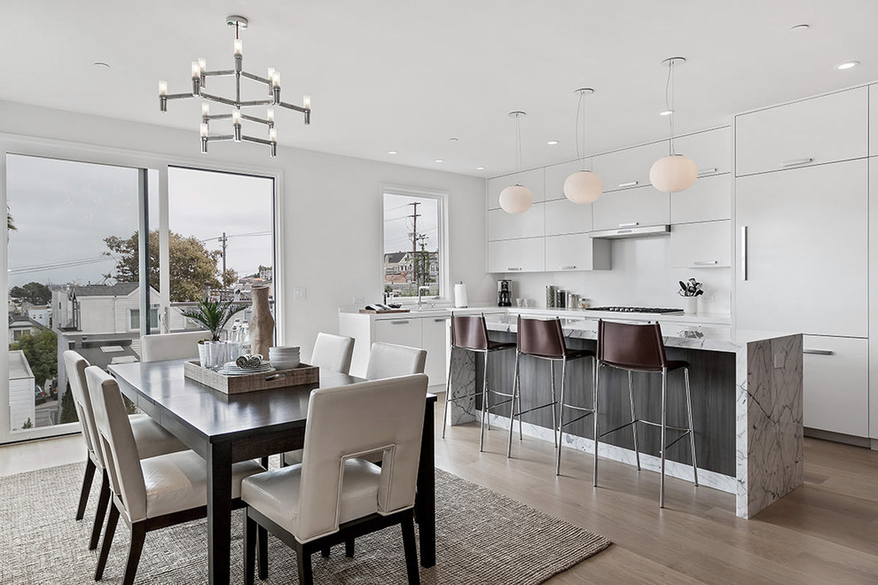 Design ideas for a mid-sized contemporary open plan dining in San Francisco with white walls and light hardwood floors.