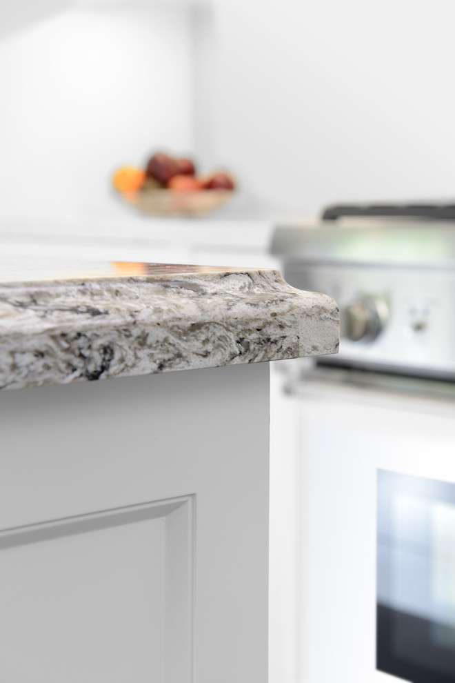 Mid-sized transitional l-shaped medium tone wood floor and brown floor eat-in kitchen photo in Toronto with an undermount sink, shaker cabinets, white cabinets, quartz countertops, white backsplash, subway tile backsplash, stainless steel appliances and an island