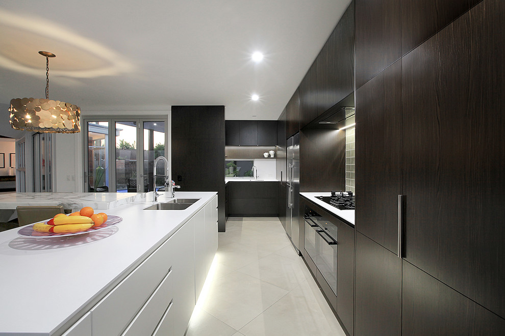 Design ideas for a large modern single-wall eat-in kitchen in Sunshine Coast with a double-bowl sink, flat-panel cabinets, brown cabinets, marble benchtops, grey splashback, glass tile splashback, stainless steel appliances, ceramic floors and with island.