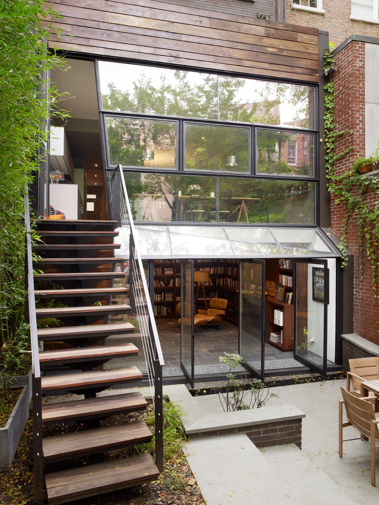 Photo of a contemporary brown townhouse exterior in New York with wood siding.