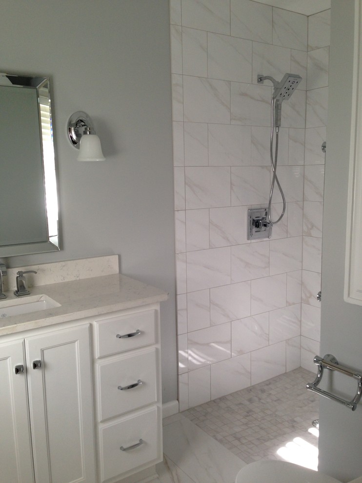 Example of a small transitional master white tile and porcelain tile porcelain tile and white floor walk-in shower design in Atlanta with an undermount sink, recessed-panel cabinets, white cabinets, quartz countertops, gray walls and white countertops