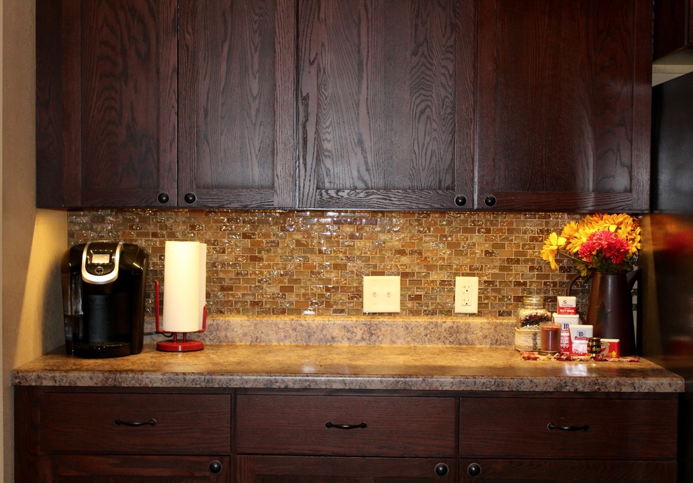 Inspiration for a large transitional single-wall slate floor and beige floor enclosed kitchen remodel in Cedar Rapids with shaker cabinets, dark wood cabinets, limestone countertops, beige backsplash, mosaic tile backsplash, stainless steel appliances and no island