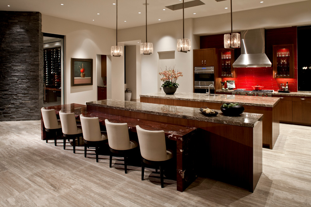 Inspiration for a large contemporary single-wall open plan kitchen in San Diego with flat-panel cabinets, medium wood cabinets, marble benchtops, red splashback, glass tile splashback, stainless steel appliances, multiple islands, a single-bowl sink, travertine floors and beige floor.
