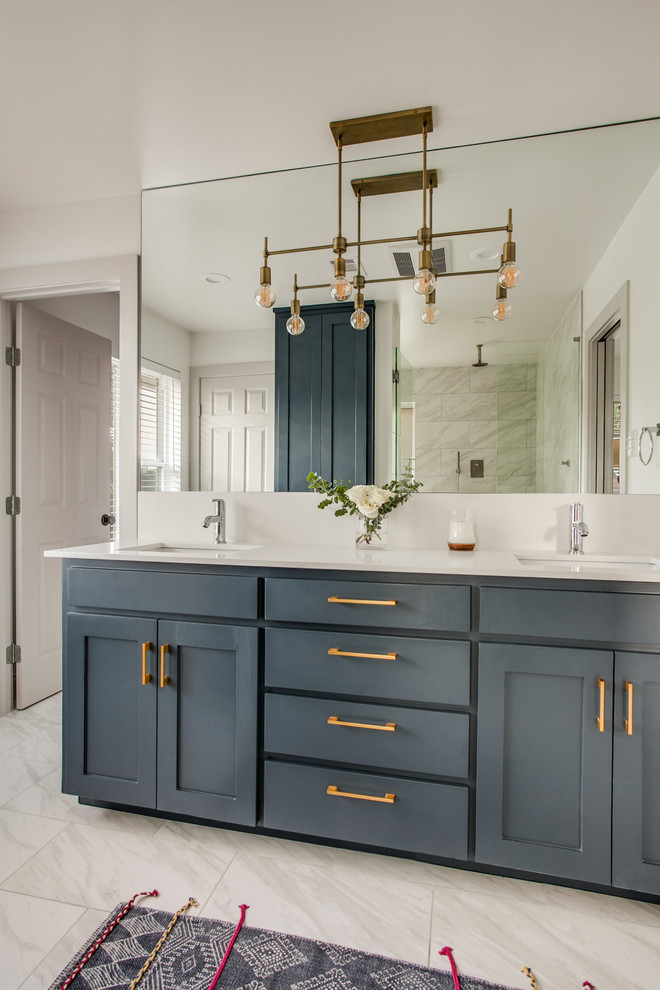 Photo of a mid-sized transitional master wet room bathroom in Dallas with shaker cabinets, blue cabinets, a freestanding tub, a two-piece toilet, gray tile, porcelain tile, white walls, porcelain floors, an undermount sink, engineered quartz benchtops, grey floor, a hinged shower door and white benchtops.