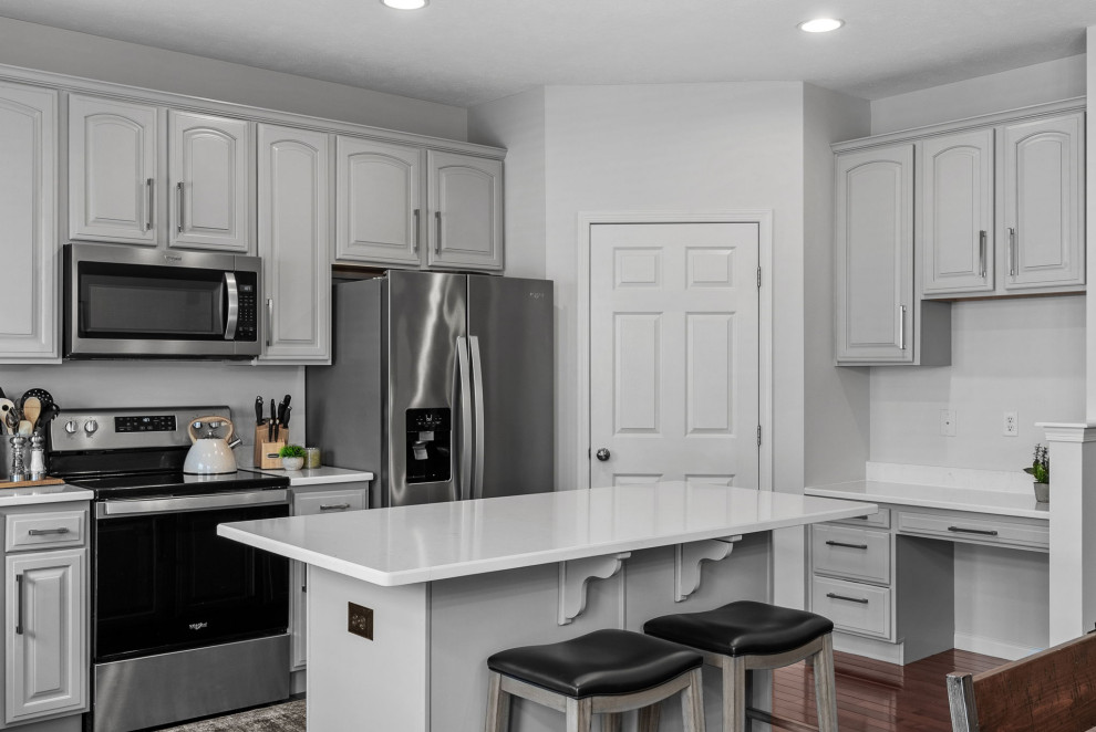 Eat-in kitchen - transitional dark wood floor eat-in kitchen idea with a double-bowl sink, gray cabinets, quartz countertops, stainless steel appliances, an island and white countertops