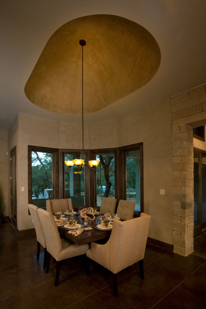 Design ideas for a transitional dining room in Austin with concrete floors.