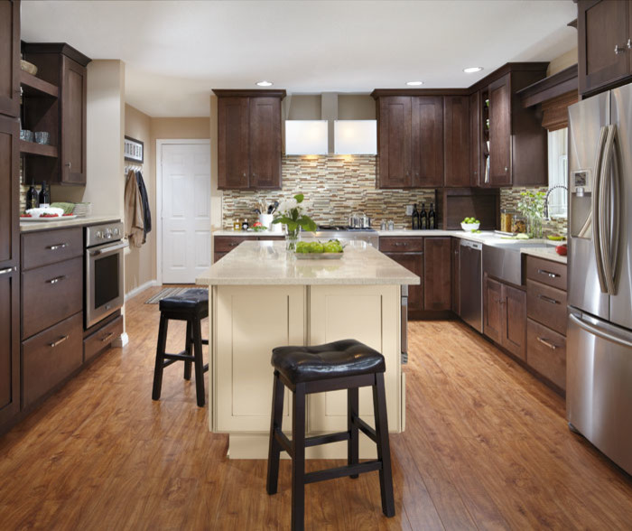 Design ideas for a large transitional u-shaped separate kitchen in Cedar Rapids with a farmhouse sink, shaker cabinets, dark wood cabinets, quartzite benchtops, brown splashback, matchstick tile splashback, stainless steel appliances, medium hardwood floors, with island and brown floor.