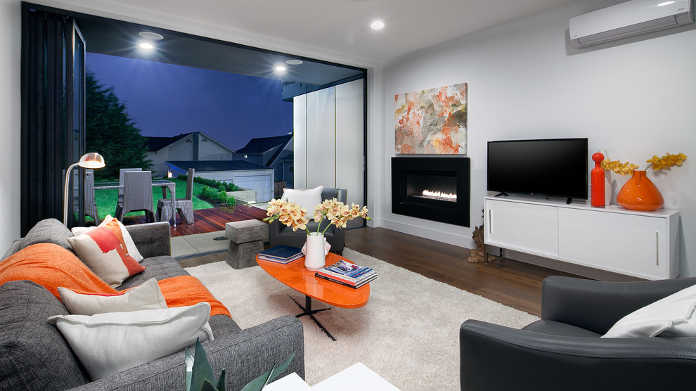 Photo of a contemporary family room in Seattle with white walls, a ribbon fireplace, a metal fireplace surround and dark hardwood floors.
