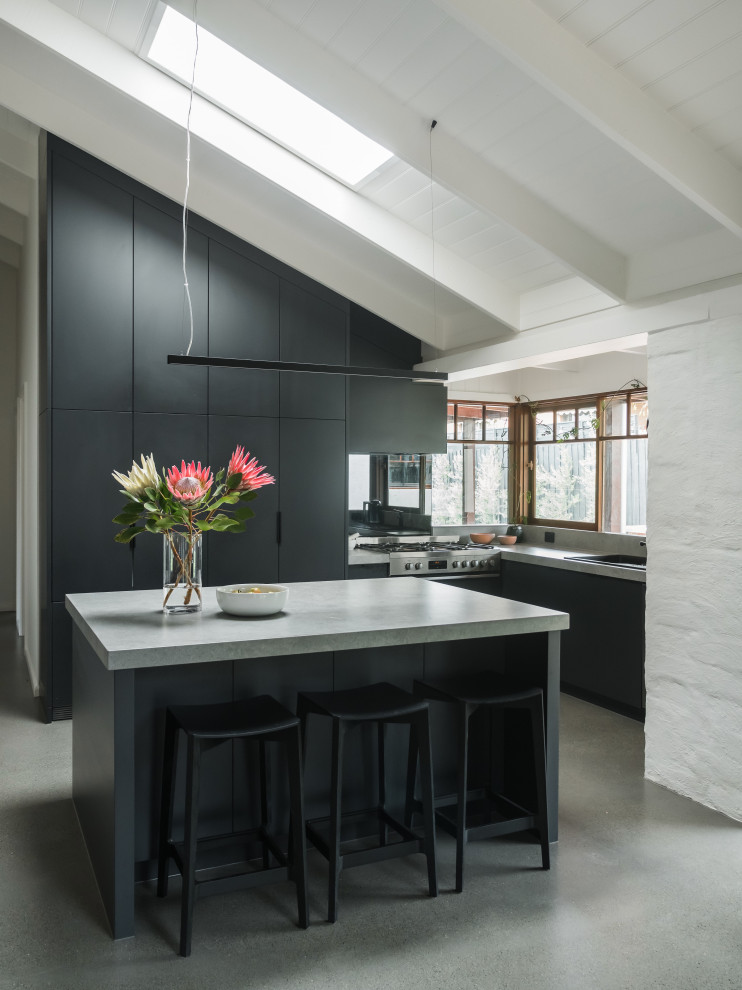 Contemporary kitchen in Melbourne with concrete floors.