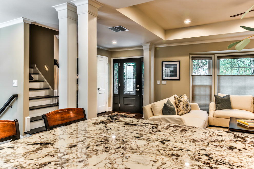 Large transitional l-shaped medium tone wood floor open concept kitchen photo in Atlanta with an undermount sink, shaker cabinets, white cabinets, granite countertops, white backsplash, subway tile backsplash, stainless steel appliances and an island