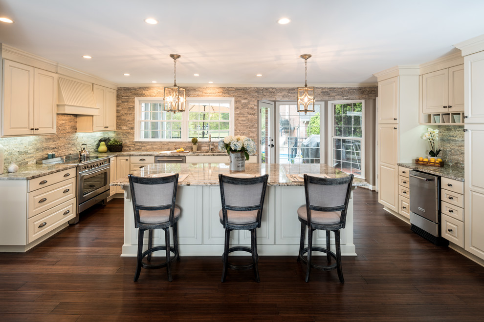 Large traditional u-shaped eat-in kitchen in Atlanta with an undermount sink, raised-panel cabinets, granite benchtops, stainless steel appliances, bamboo floors, with island, brown floor, white cabinets, brown splashback, stone tile splashback and multi-coloured benchtop.