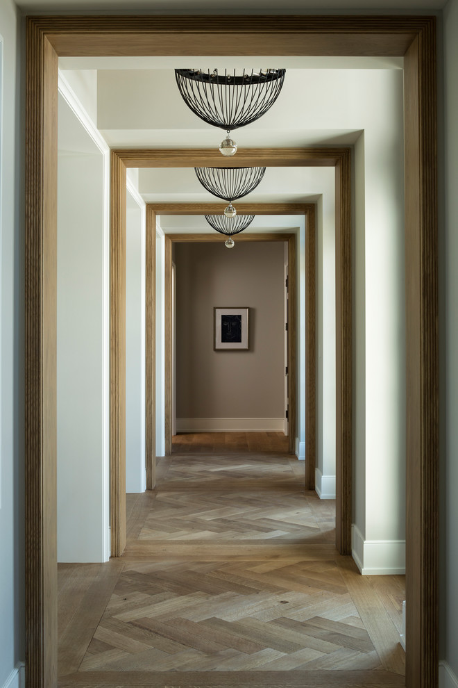Large eclectic medium tone wood floor and brown floor hallway photo in Minneapolis with beige walls