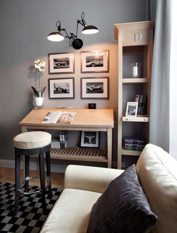 Traditional home studio in Moscow with grey walls, a freestanding desk and light hardwood floors.