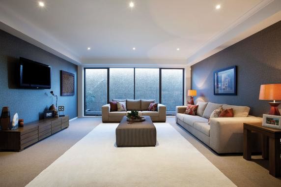 Photo of a large contemporary open concept home theatre in Melbourne with brown walls, carpet and a wall-mounted tv.