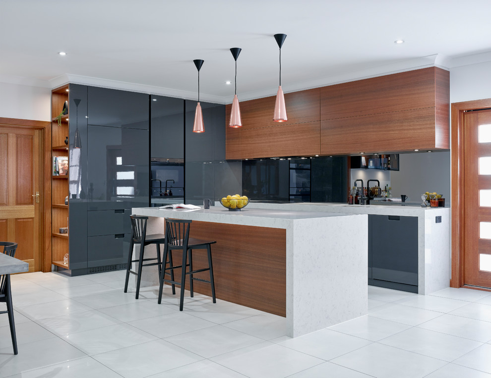 Inspiration for a mid-sized contemporary l-shaped eat-in kitchen in Other with flat-panel cabinets, mirror splashback, white floor, grey cabinets, panelled appliances and with island.