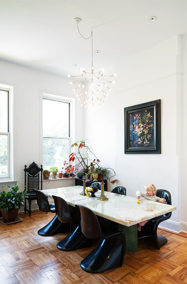 This is an example of a contemporary dining room in New York with white walls, medium hardwood floors and orange floor.
