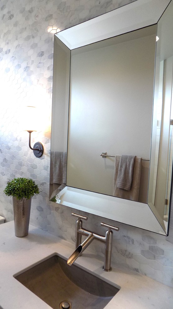 This is an example of a mid-sized country bathroom in San Luis Obispo with raised-panel cabinets, white cabinets, an alcove tub, a shower/bathtub combo, a one-piece toilet, multi-coloured tile, mosaic tile, grey walls, ceramic floors, an undermount sink and engineered quartz benchtops.