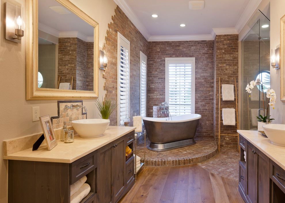 Design ideas for a large country master bathroom in Tampa with a pedestal sink, flat-panel cabinets, grey cabinets, granite benchtops, a freestanding tub, a double shower, beige walls and medium hardwood floors.