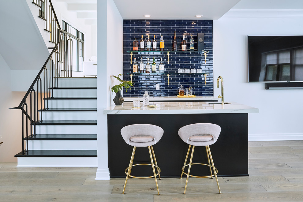 Inspiration for a mid-sized contemporary wet bar in New York with an undermount sink, marble benchtops, blue splashback, subway tile splashback and white benchtop.