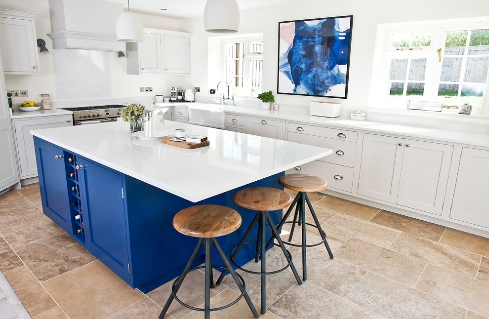 Photo of a mid-sized transitional l-shaped kitchen in Other with a farmhouse sink, grey splashback, stainless steel appliances, with island, beige floor, white benchtop, shaker cabinets, grey cabinets and stone slab splashback.