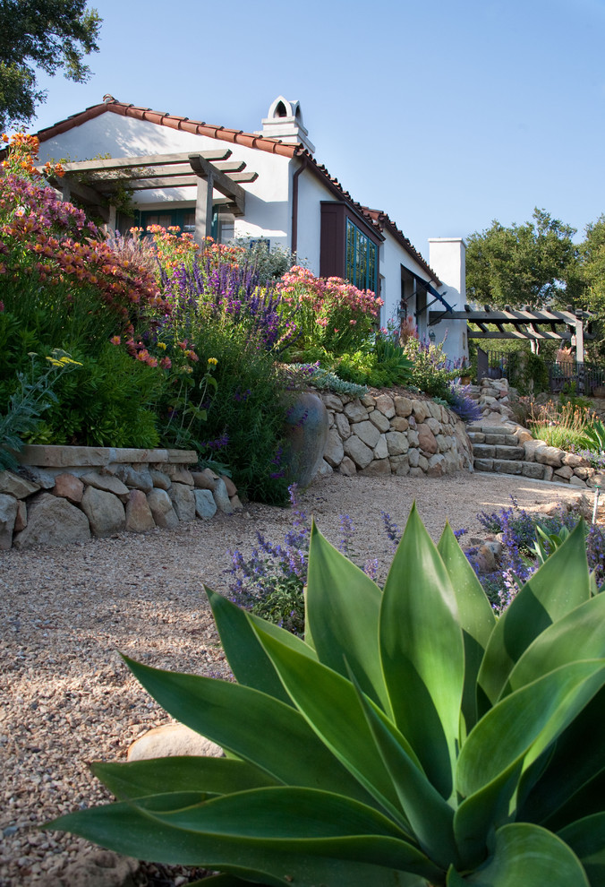Photo of an expansive mediterranean sloped garden in Santa Barbara with gravel.