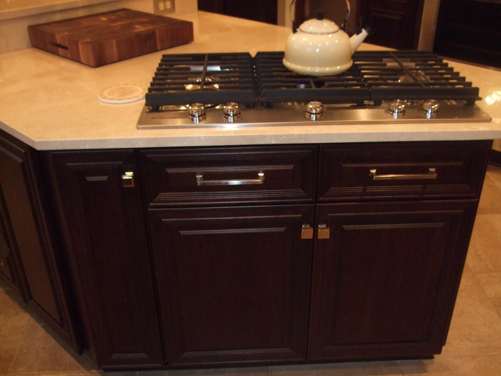 Kitchen - large transitional kitchen idea with a single-bowl sink, raised-panel cabinets, dark wood cabinets, marble countertops, stainless steel appliances and an island