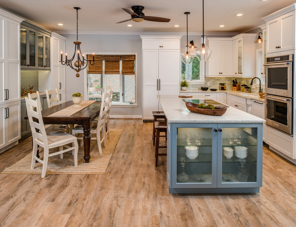 Inspiration for a mid-sized transitional medium tone wood floor and multicolored floor eat-in kitchen remodel with an undermount sink, shaker cabinets, gray cabinets, quartz countertops, blue backsplash, mosaic tile backsplash, stainless steel appliances, an island and multicolored countertops