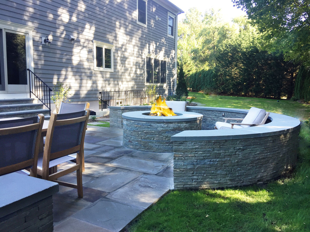 Design ideas for a small contemporary backyard patio in New York with an outdoor kitchen and natural stone pavers.