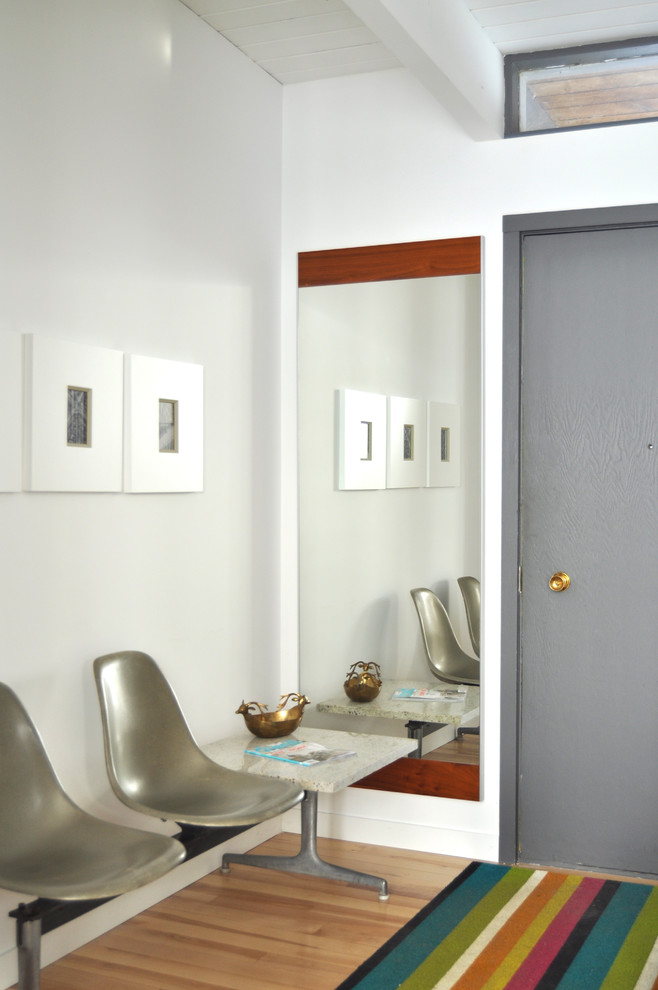 Photo of a midcentury entryway in Other with a single front door and a gray front door.