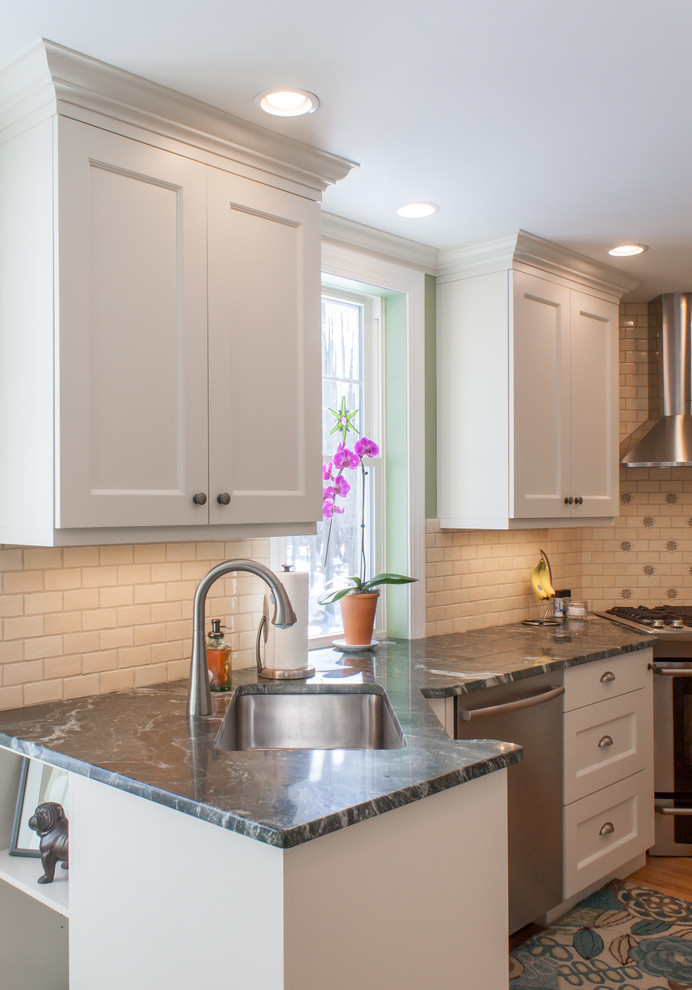 Inspiration for a small traditional u-shaped eat-in kitchen in Boston with a single-bowl sink, recessed-panel cabinets, white cabinets, granite benchtops, beige splashback, ceramic splashback, stainless steel appliances and medium hardwood floors.