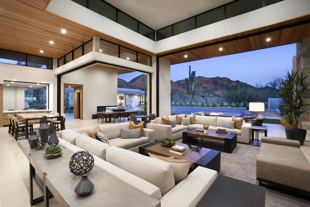 Design ideas for an expansive contemporary open concept family room in Phoenix with white walls, a two-sided fireplace and a wall-mounted tv.