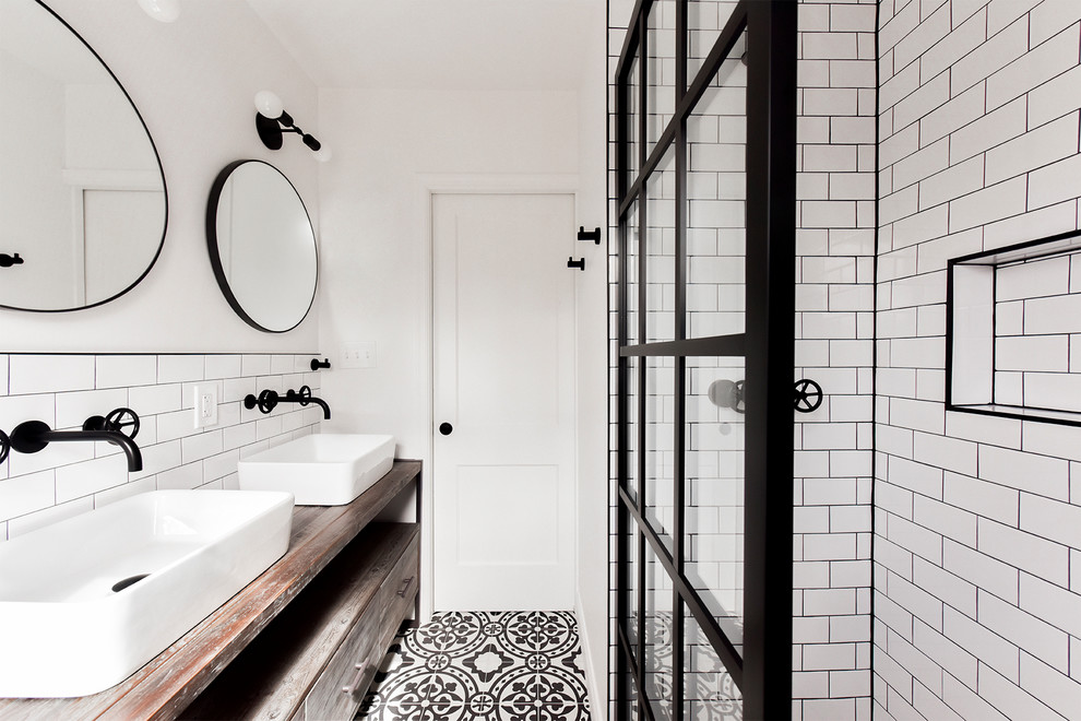 Bathroom - industrial white tile and subway tile cement tile floor and multicolored floor bathroom idea in DC Metro with medium tone wood cabinets, white walls, a vessel sink, wood countertops, brown countertops and flat-panel cabinets