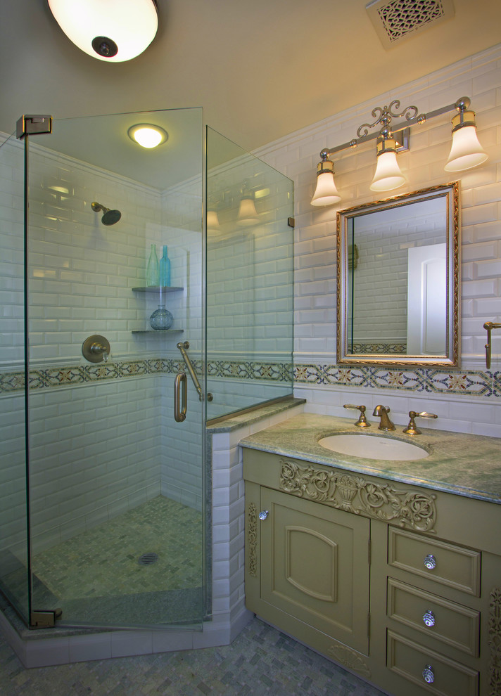 This is an example of a traditional bathroom in Boston with marble benchtops and subway tile.