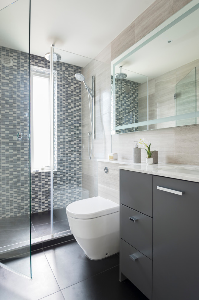 Photo of a contemporary bathroom in London with an undermount sink, flat-panel cabinets, grey cabinets, multi-coloured tile and mosaic tile.